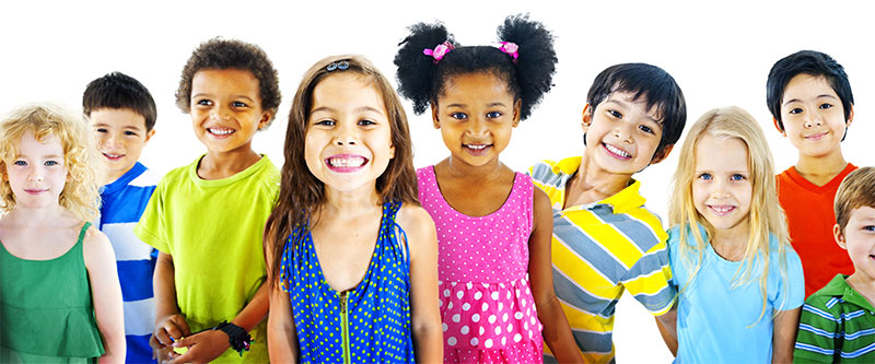 The image shows a group of children with diverse skin tones and attire, standing together and smiling for the camera.